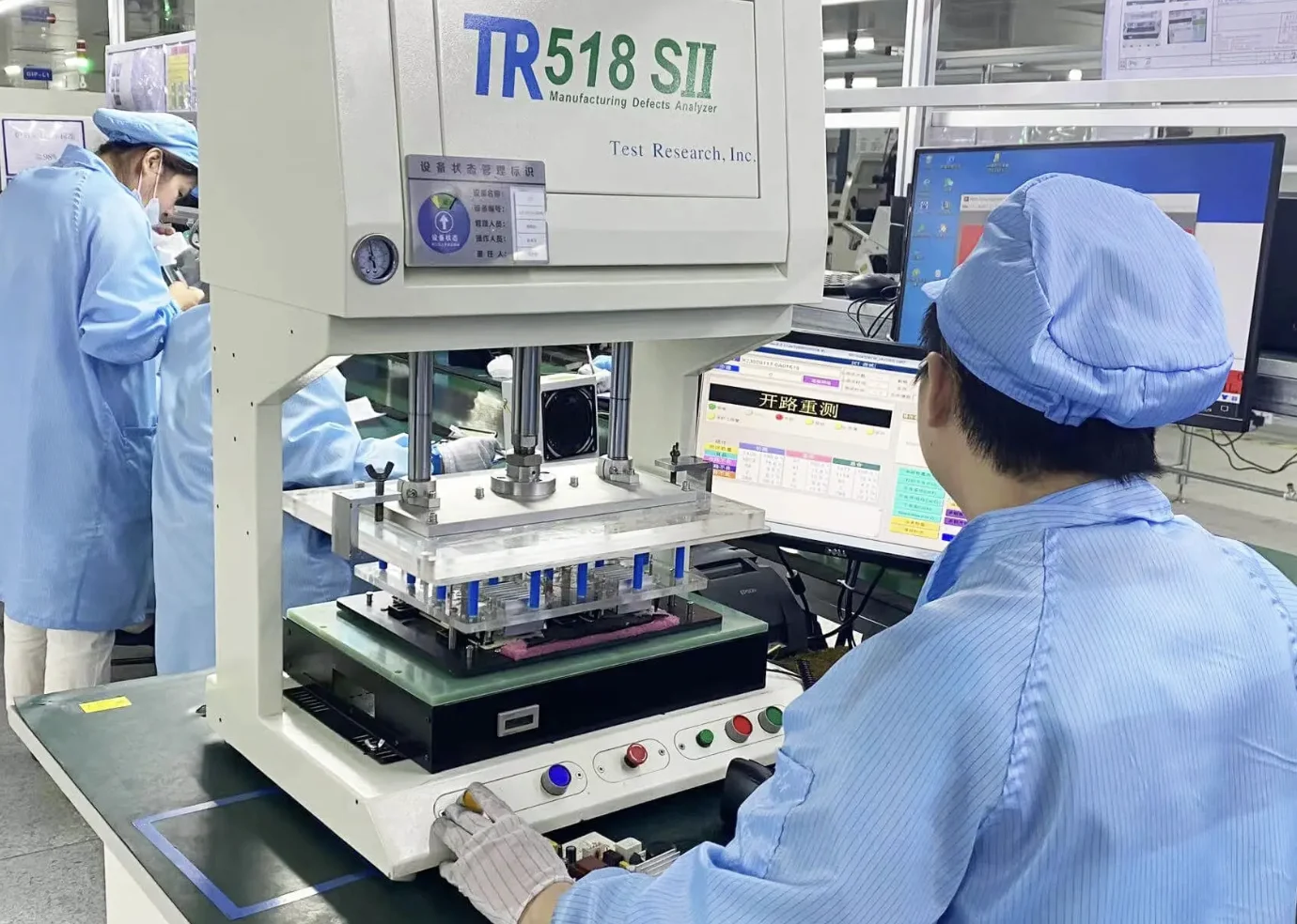Operator inspecting printed circuit boards using automated test equipment